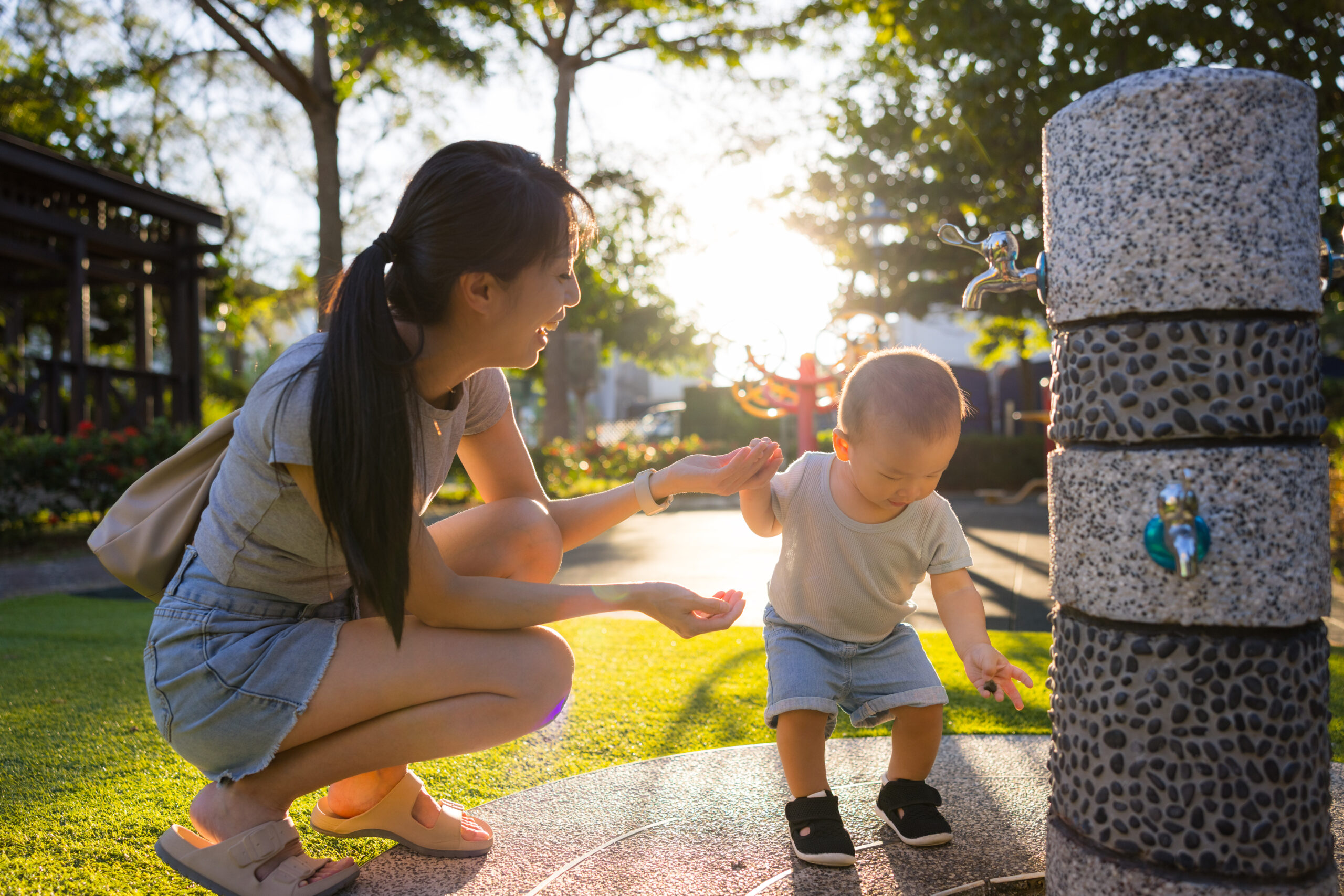 Mother and baby enjoying a sunny day at the park, illustrating how to save water in Florida through outdoor activities.